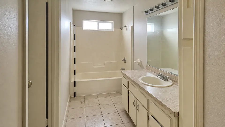 Bathroom condition image with a visible tub, vanity, and measurement reference