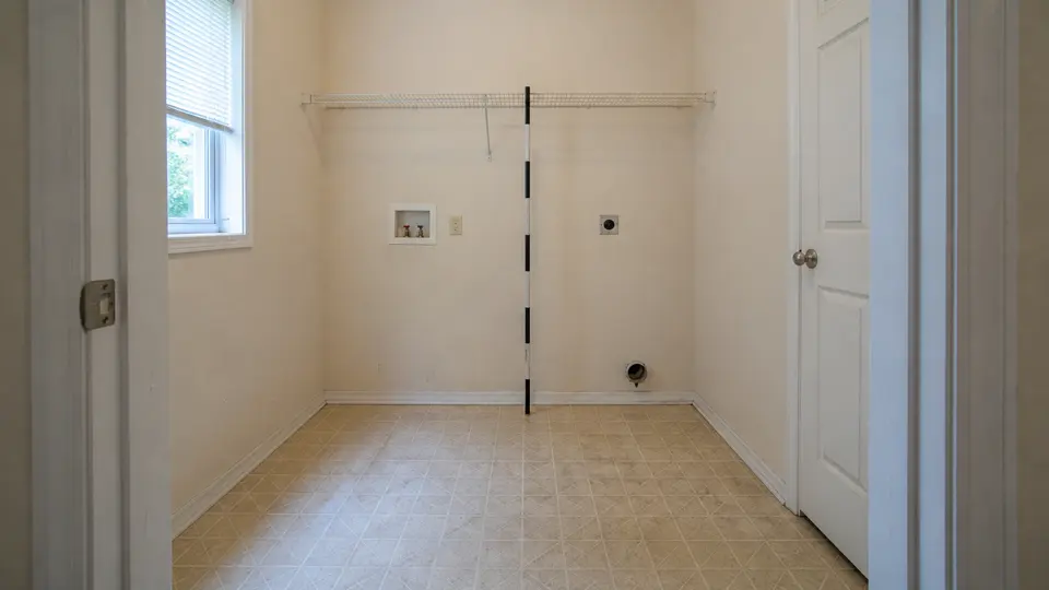Laundry room condition image with a shelf and two visible hookups
