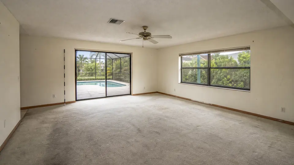 Living room condition image with a sliding door and adjacent window